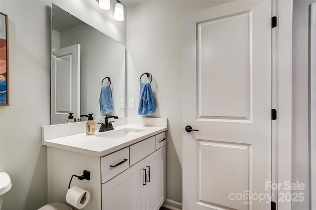 half bath featuring toilet and vanity