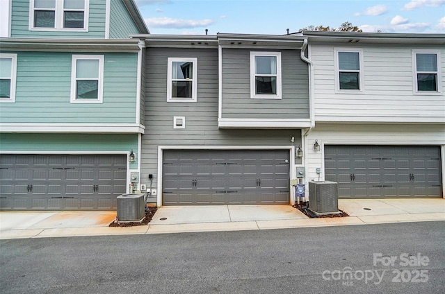view of front of property featuring cooling unit and a garage