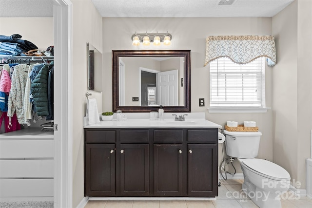 512 Red Oak Ct, Tega Cay, SC 29708 - full bath featuring a textured ceiling, visible vents, toilet, vanity, and tile patterned flooring