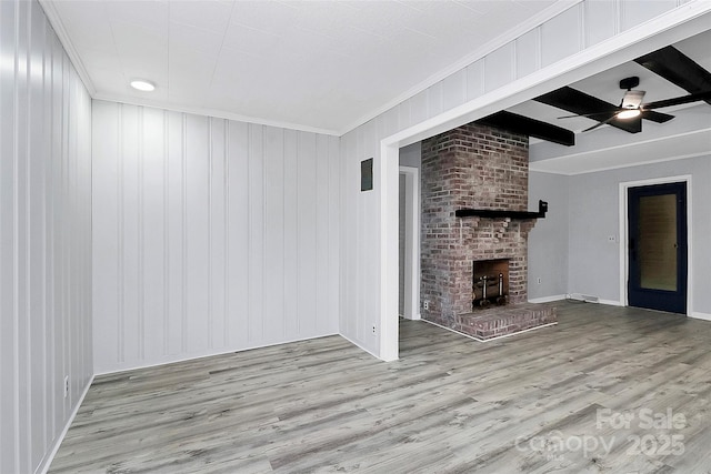 unfurnished living room featuring crown molding, beamed ceiling, wood finished floors, and a ceiling fan