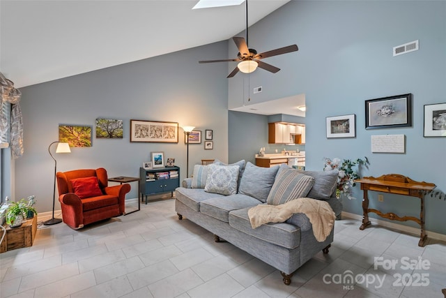 407 Sweeten Way, Asheville, NC 28803 - living room featuring a ceiling fan, light tile patterned floors, baseboards, visible vents, and lofted ceiling with skylight