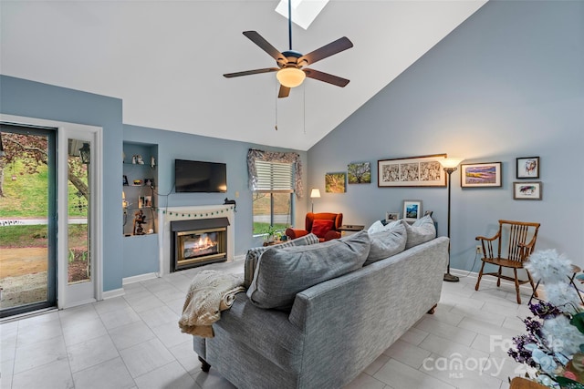 407 Sweeten Way, Asheville, NC 28803 - living room with high vaulted ceiling, a ceiling fan, built in features, a glass covered fireplace, and light tile patterned floors