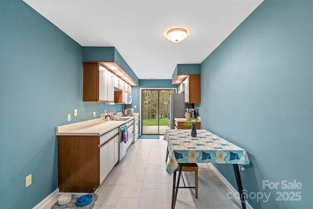407 Sweeten Way, Asheville, NC 28803 - kitchen featuring light countertops, light tile patterned floors, baseboards, a sink, and appliances with stainless steel finishes
