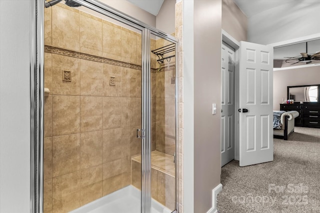bathroom featuring a stall shower, ceiling fan, and connected bathroom