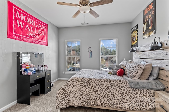carpeted bedroom featuring visible vents, baseboards, and ceiling fan