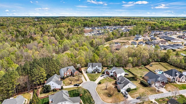 birds eye view of property with a wooded view and a residential view