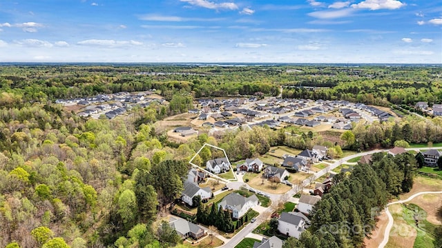 drone / aerial view with a forest view and a residential view