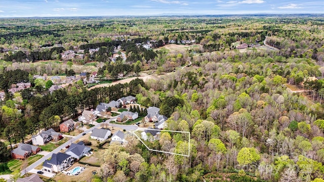 drone / aerial view with a view of trees and a residential view