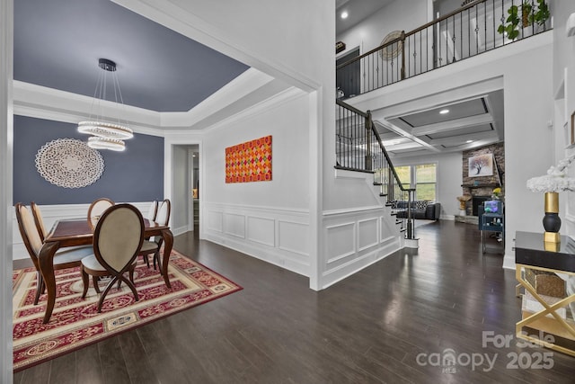 10904 Kilkenny Dr, Matthews, NC 28105 - dining area featuring stairs, a chandelier, ornamental molding, coffered ceiling, and wood finished floors