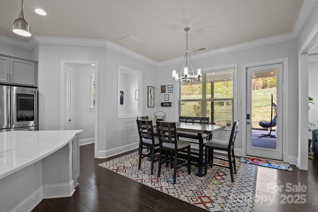 10904 Kilkenny Dr, Matthews, NC 28105 - dining room featuring dark wood-type flooring, a chandelier, crown molding, and recessed lighting