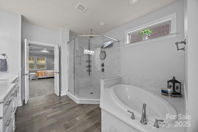 10904 Kilkenny Dr, Matthews, NC 28105 - full bathroom with a shower stall, vanity, a garden tub, connected bathroom, and wood finished floors