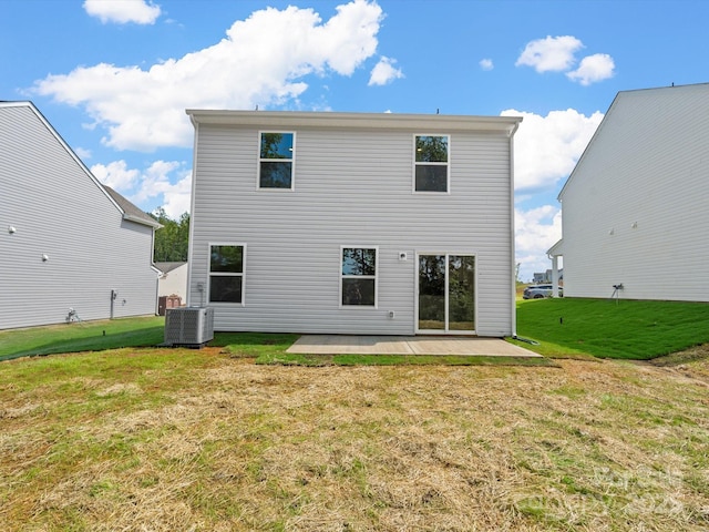 rear view of property with a patio, central AC unit, and a lawn