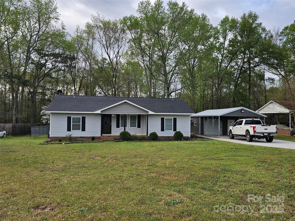 2021 Hilton Way Rd, Lancaster, SC 29720 - ranch-style house featuring roof with shingles, a front yard, fence, and concrete driveway