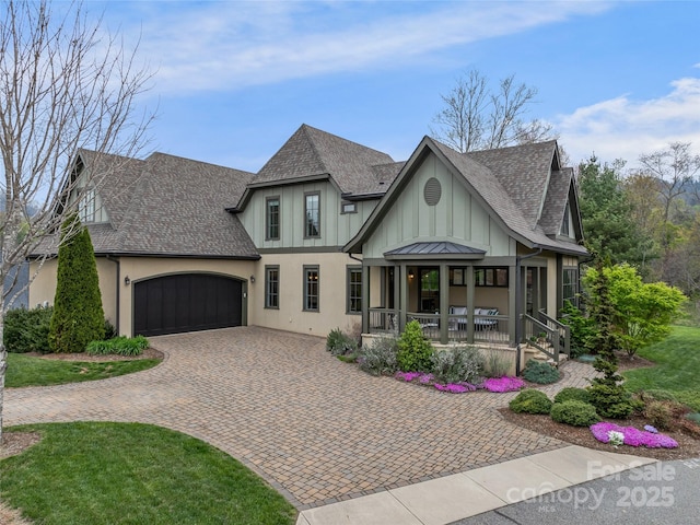 17 Kiftsgate Ct, Asheville, NC 28804 - view of front of home featuring a shingled roof, stucco siding, covered porch, decorative driveway, and a garage