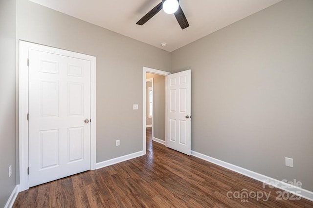 1314 39th Street Cir SW, Hickory, NC 28602 - unfurnished bedroom with baseboards, dark wood-style floors, and a ceiling fan