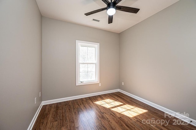 1314 39th Street Cir SW, Hickory, NC 28602 - spare room with dark wood-style floors, visible vents, ceiling fan, and baseboards