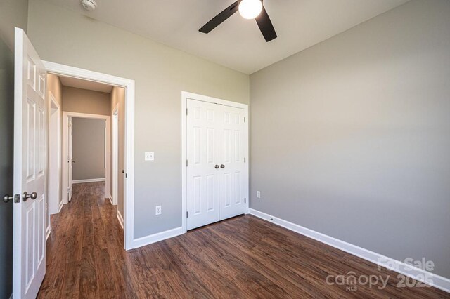 1314 39th Street Cir SW, Hickory, NC 28602 - unfurnished bedroom with baseboards, dark wood-style flooring, ceiling fan, and a closet