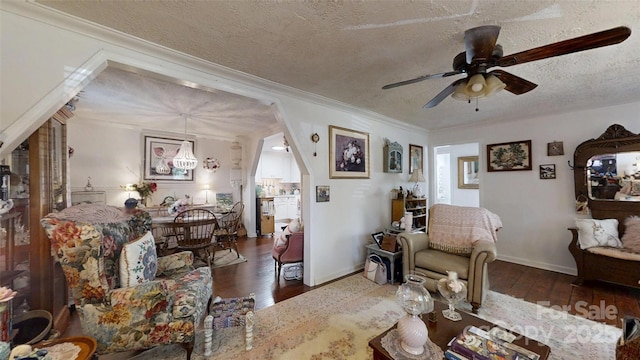 608 Forney Ave, Lincolnton, NC 28092 - living room featuring baseboards, ornamental molding, a textured ceiling, a ceiling fan, and hardwood / wood-style flooring