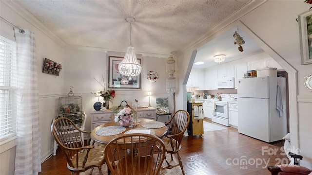608 Forney Ave, Lincolnton, NC 28092 - dining room with dark wood-style floors, an inviting chandelier, and crown molding