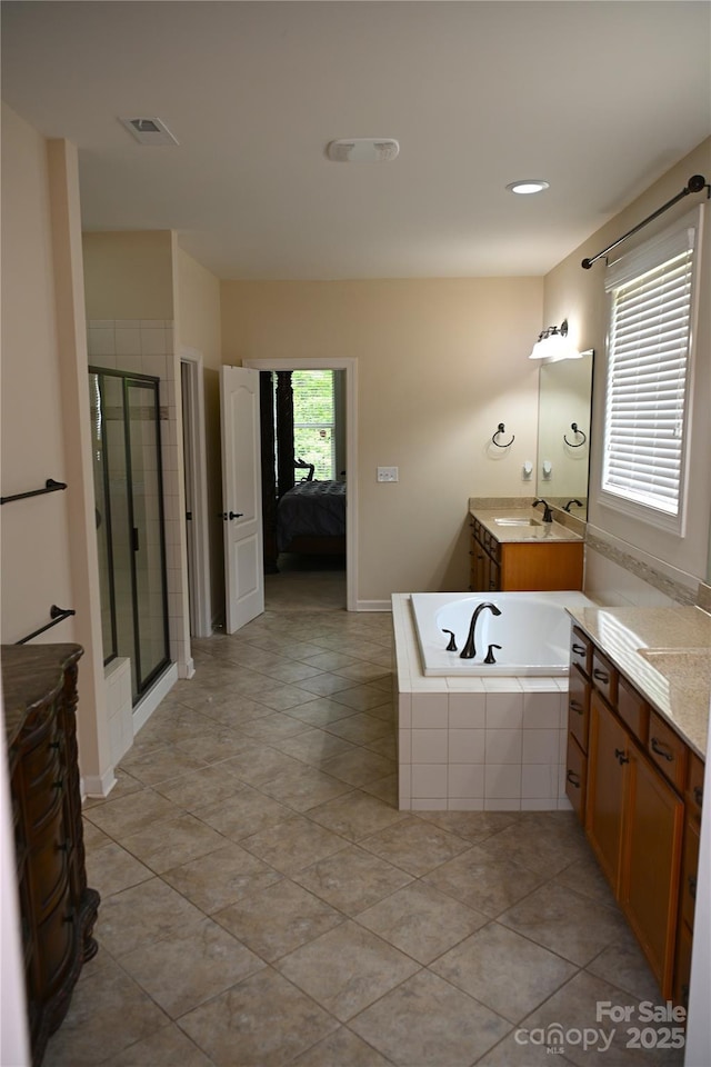 bathroom featuring a stall shower, ensuite bath, a bath, vanity, and tile patterned flooring