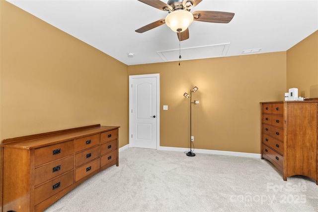 bedroom with attic access, light colored carpet, baseboards, and a ceiling fan