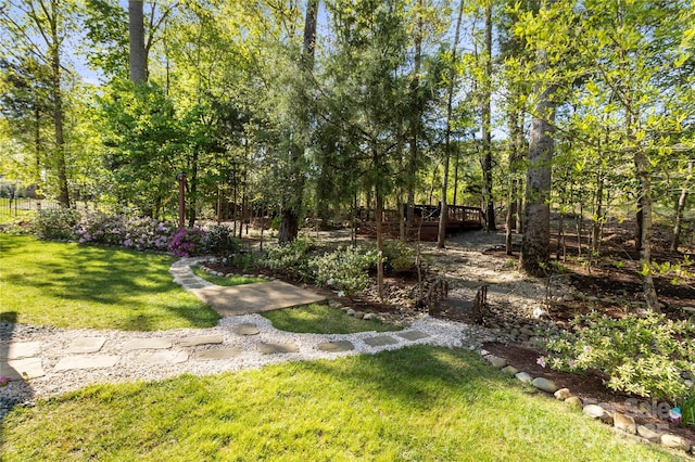view of green lawn featuring a deck