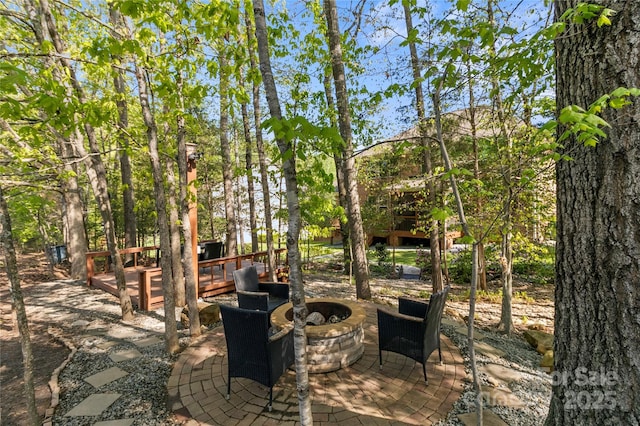 view of patio with an outdoor fire pit and a wooden deck