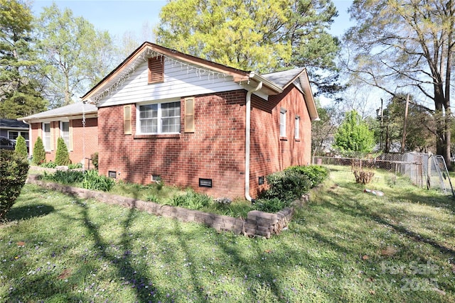 3220 Wiseman Dr, Charlotte, NC 28227 - view of side of home featuring brick siding, fence, and a yard