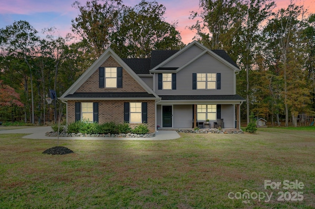 3018 Corinth Church Rd, Monroe, NC 28112 - traditional-style house featuring covered porch, a front lawn, and brick siding