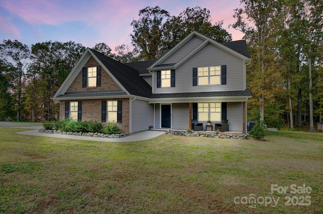 3018 Corinth Church Rd, Monroe, NC 28112 - traditional-style home with covered porch, a lawn, brick siding, and cooling unit