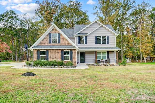 3018 Corinth Church Rd, Monroe, NC 28112 - view of front facade featuring a front lawn, covered porch, and brick siding
