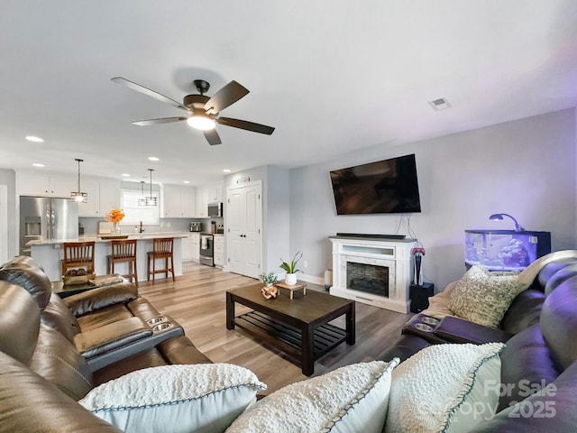 3018 Corinth Church Rd, Monroe, NC 28112 - living area with light wood-style flooring, ceiling fan, recessed lighting, a fireplace, and baseboards