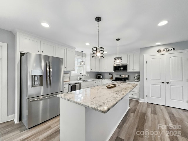 3018 Corinth Church Rd, Monroe, NC 28112 - kitchen featuring appliances with stainless steel finishes, a sink, white cabinetry, recessed lighting, and light wood-style flooring