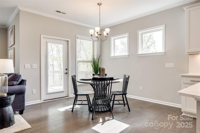 dining area with dark wood-style flooring, visible vents, crown molding, baseboards, and an inviting chandelier