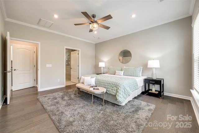 bedroom with wood finished floors, crown molding, baseboards, and visible vents