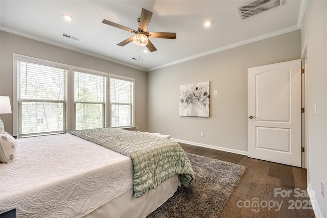 bedroom with dark wood finished floors, visible vents, and crown molding