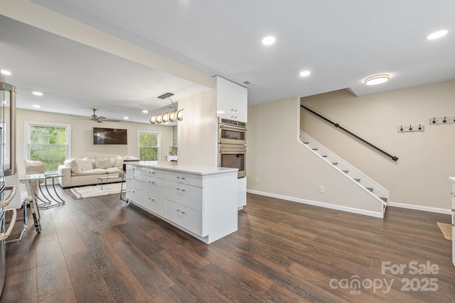8308 Knights Bridge Rd, Charlotte, NC 28210 - kitchen with double oven, open floor plan, white cabinetry, and dark wood-style floors