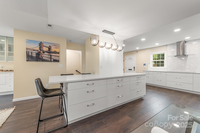 8308 Knights Bridge Rd, Charlotte, NC 28210 - kitchen with white cabinets, dark wood finished floors, wall chimney exhaust hood, and visible vents