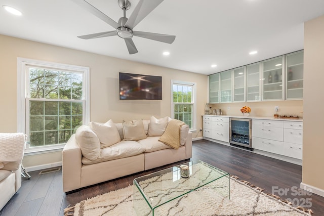 8308 Knights Bridge Rd, Charlotte, NC 28210 - living room featuring dark wood-style floors, baseboards, a bar, a ceiling fan, and beverage cooler