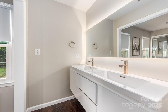 8308 Knights Bridge Rd, Charlotte, NC 28210 - bathroom featuring baseboards, wood finished floors, a sink, and double vanity