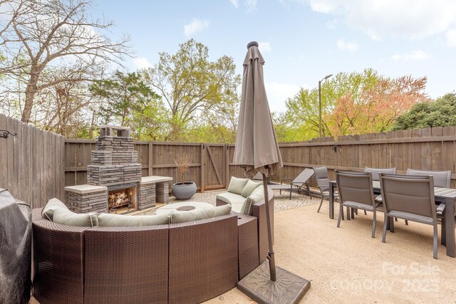 8308 Knights Bridge Rd, Charlotte, NC 28210 - view of patio with an outdoor living space with a fireplace, a fenced backyard, and outdoor dining area