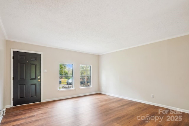 entryway with baseboards, crown molding, wood finished floors, and a textured ceiling