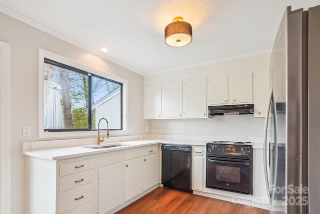 kitchen with a sink, freestanding refrigerator, dishwasher, under cabinet range hood, and electric stove