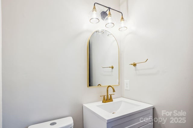 half bathroom featuring toilet and vanity