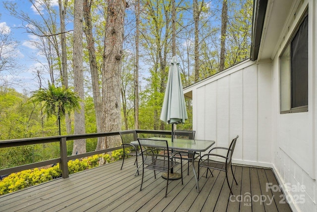 wooden deck with outdoor dining space