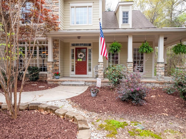 6108 Mcilwaine Rd, Huntersville, NC 28078 - doorway to property featuring roof with shingles, a porch, and stone siding