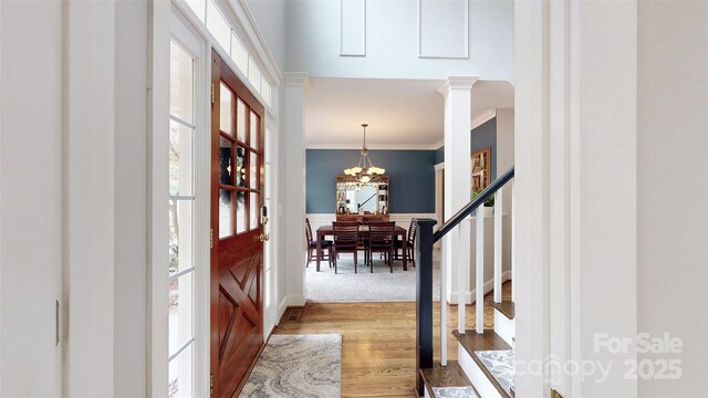 6108 Mcilwaine Rd, Huntersville, NC 28078 - foyer entrance featuring a chandelier, wood finished floors, stairs, and ornamental molding