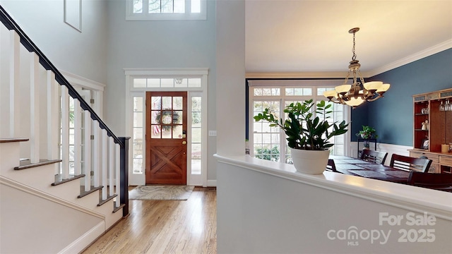 6108 Mcilwaine Rd, Huntersville, NC 28078 - entryway featuring wood finished floors, a towering ceiling, stairs, and a notable chandelier