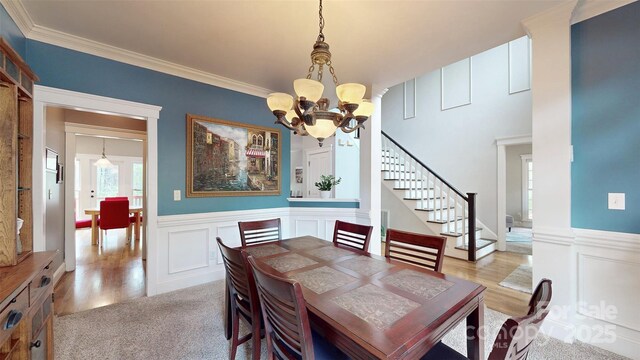 6108 Mcilwaine Rd, Huntersville, NC 28078 - dining space featuring stairway, ornamental molding, a wainscoted wall, and a chandelier