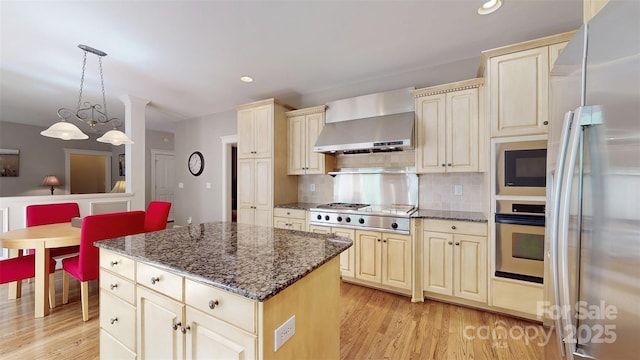 6108 Mcilwaine Rd, Huntersville, NC 28078 - kitchen featuring cream cabinets, wall chimney exhaust hood, appliances with stainless steel finishes, and light wood finished floors